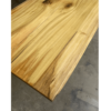 A detailed view of the Ready To Ship - Rainbow Poplar Single Slab Dakota Table, highlighting the rich wood grain, knots, and smooth edges of the Rainbow Poplar in a natural finish. The single slab rests on a concrete floor, exuding a rustic appearance.
