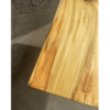 A close-up view of the Ready To Ship - Rainbow Poplar Single Slab Dakota Table surface crafted from a single slab of Rainbow Poplar, showcasing its natural, polished finish. The wood displays various grain patterns and color variations ranging from light to dark tones. The table edge is rounded, set against a dark, textured floor background.